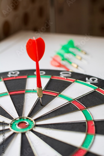 Close-up of a dart stuck in the dartboard.