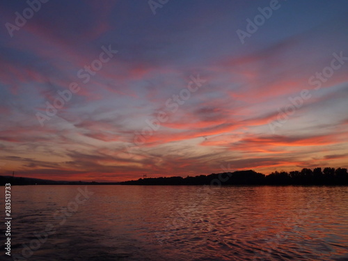 Sunset with colorful sky and clouds on the river Danube in Novi Sad