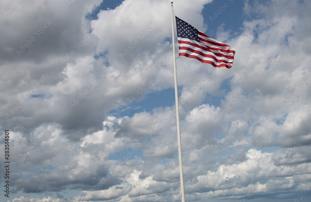 american flag waving in the wind against blue sky american flag waving in the wind against blue sky