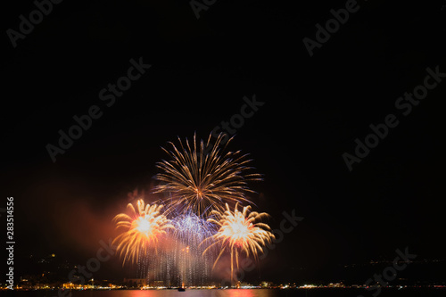 Firework show on Lake Garda, celebration (Sant Ercolano). In the city of Toscolano Maderno Italy. Aerial view. © Berg