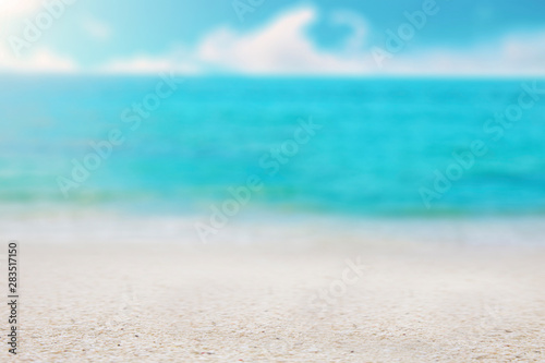 blurred tropical beach with sea sky and sunlight with white sand selective focus