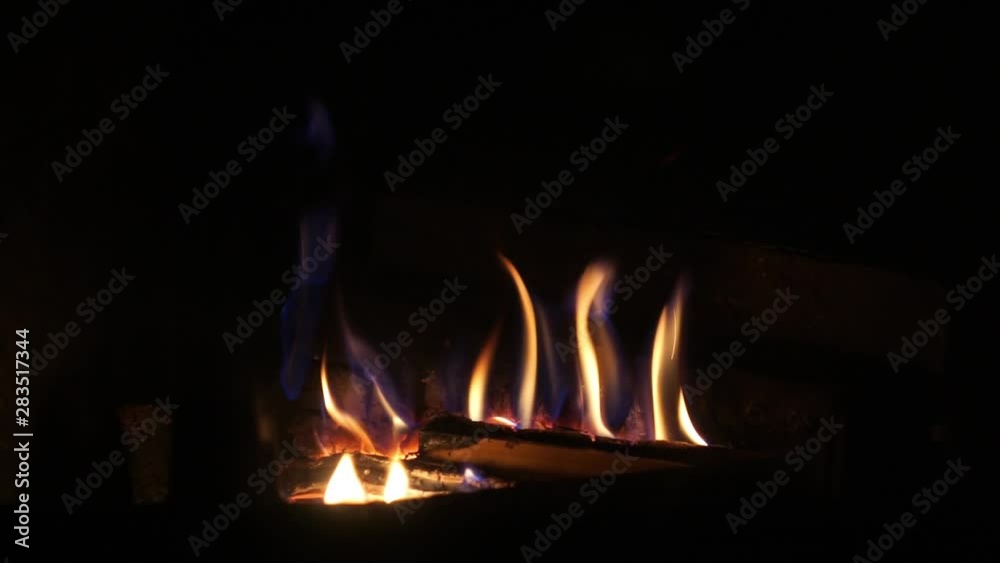 Cinemagraph Excellent satisfying close up shot on wood burning slowly with orange fire flame in cozy brickwork fireplace atmosphere. Rural life. Burning chop wood in the stone fire-place from fire Cinemagraph Excellent satisfying close up shot on wood burning slowly with orange fire flame in cozy brickwork fireplace atmosphere. Rural life. Burning chop wood in the stone fire-place from fire