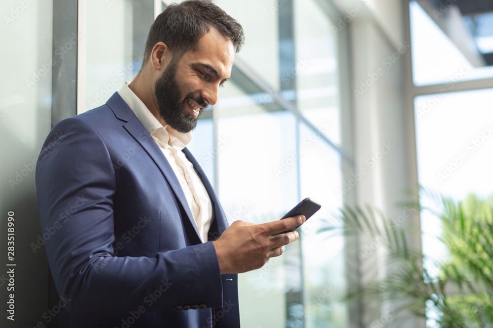 Kind bearded office worker reading good news Kind bearded office worker reading good news