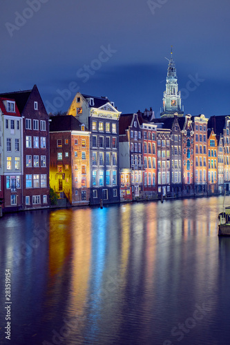 Cityscape with famous buildings in Amsterdam at night.