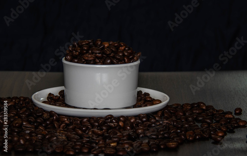 Coffee cup and coffee beans on the table