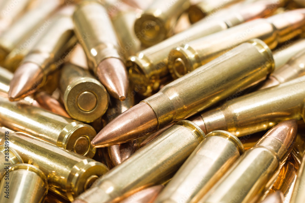 Naklejka premium Heap of golden rifle ammunition