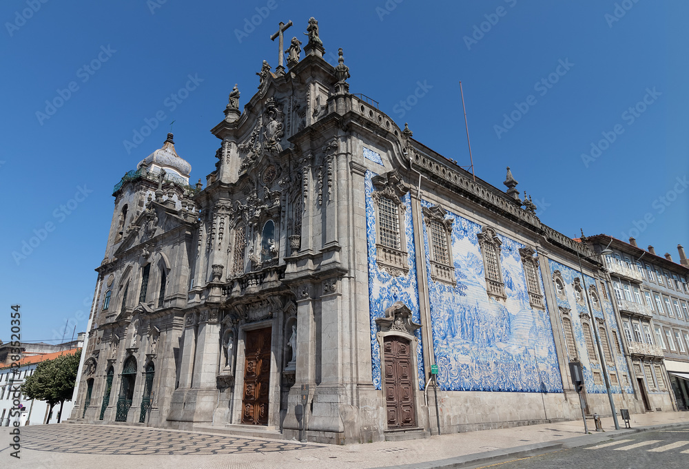 Exterior facade of Carmo church and Carmelitas church on sunny day. Baroque Portuguese architecture