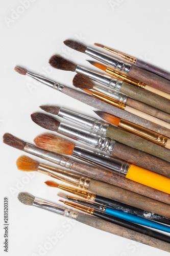 Set of real paintbrushes on white canvas