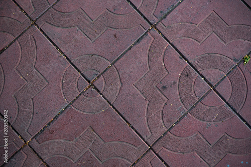 Texture of paving slabs overgrown with grass. Background image of a stratum stone