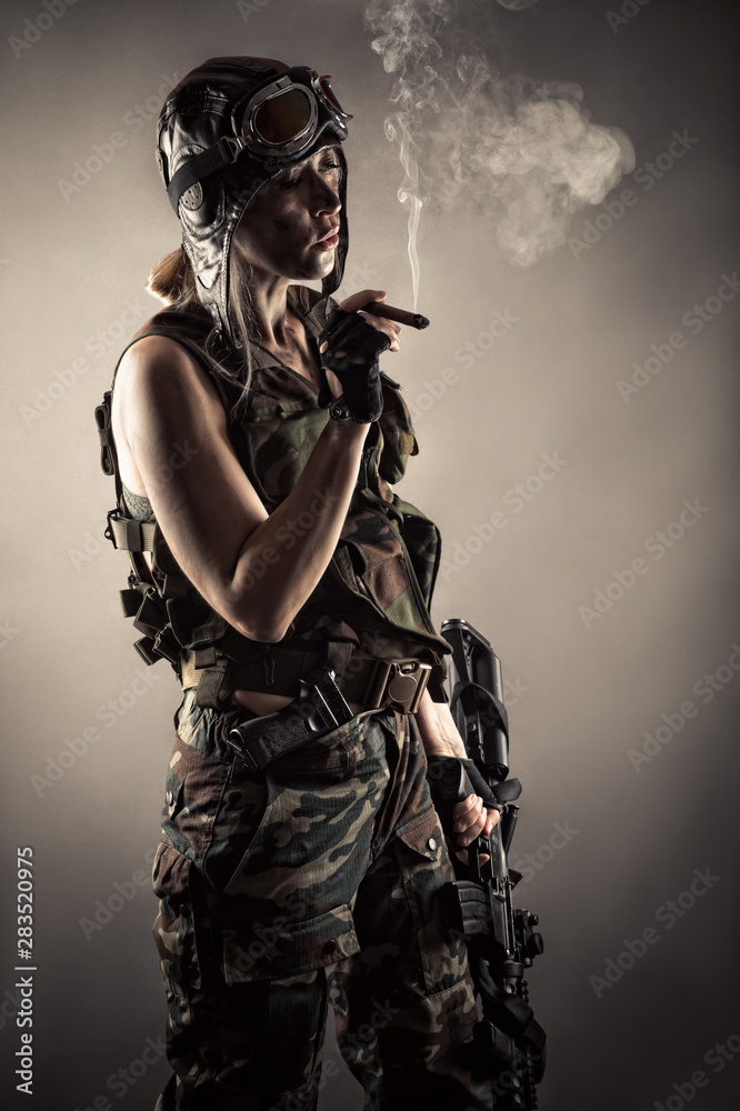 woman in uniform with guns rests smoking cigar woman in uniform with guns rests smoking cigar