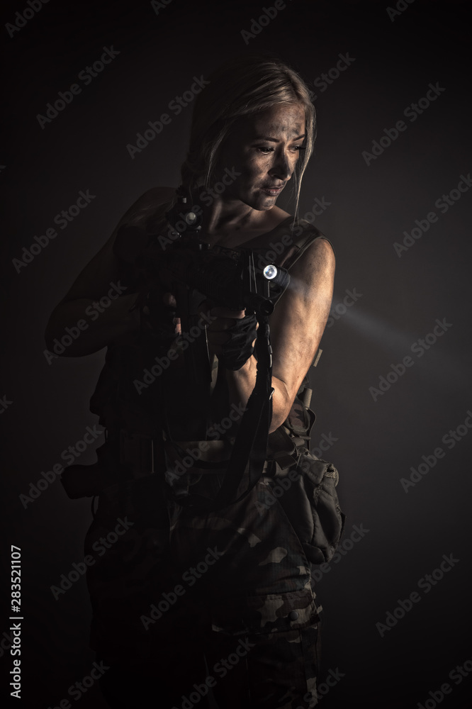 Art portrait woman with gun with flashlight in smoke Art portrait woman with gun with flashlight in smoke