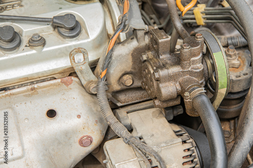 Power steering pump is leaking oil from gasket.
