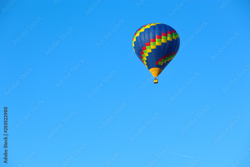 hot air balloon in the sky on a blue background hot air balloon in the sky on a blue background