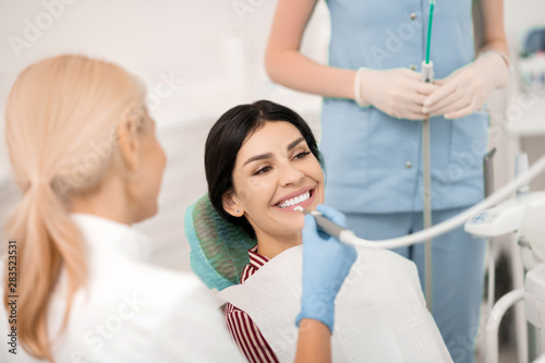 Dentist ready to start procedures for her patient.
