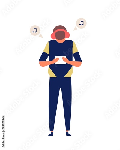 Young man holding tablet computer and listening to music track