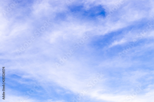 Clear blue sky with white cloud background