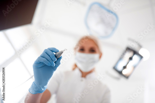 Dentist raising her hand above the patient before the procedure.