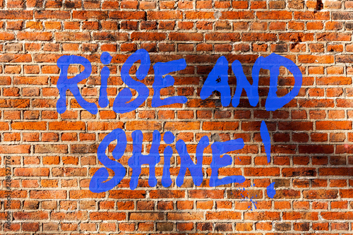 Conceptual hand writing showing Rise And Shine. Business photo text Motivation for starting a new day Be bright cheerful Brick Wall art like Graffiti motivational call written on the wall