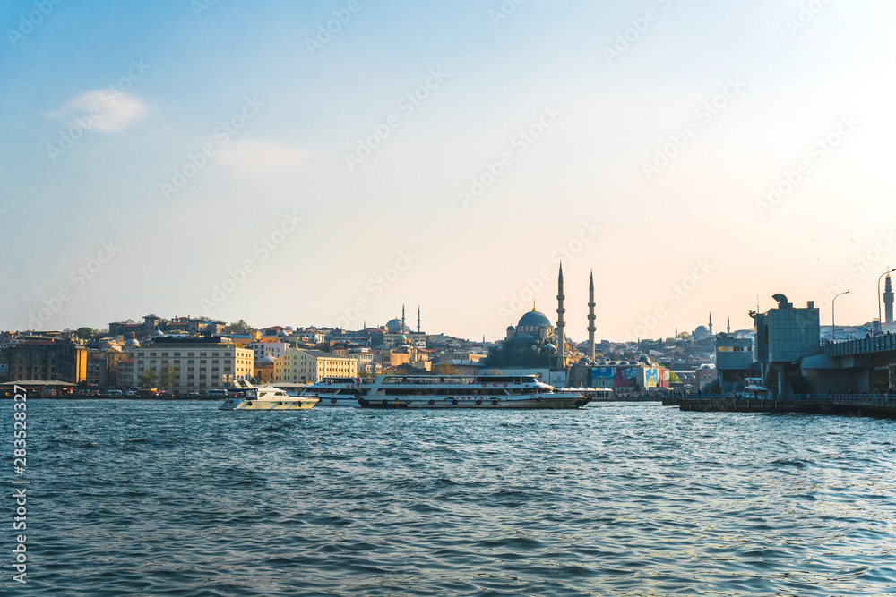 View of Istanbul cityscape Suleymaniye Mosque Hagia Sophia with floating tourist boats in Bosphorus ,Istanbul Turkey