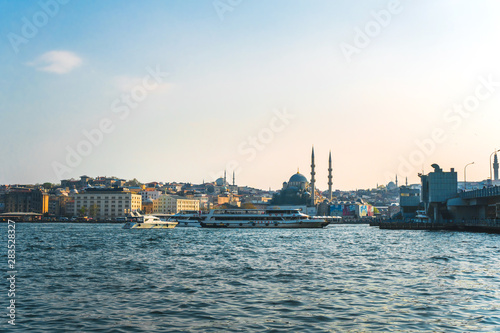 View of Istanbul cityscape Suleymaniye Mosque Hagia Sophia with floating tourist boats in Bosphorus  Istanbul Turkey
