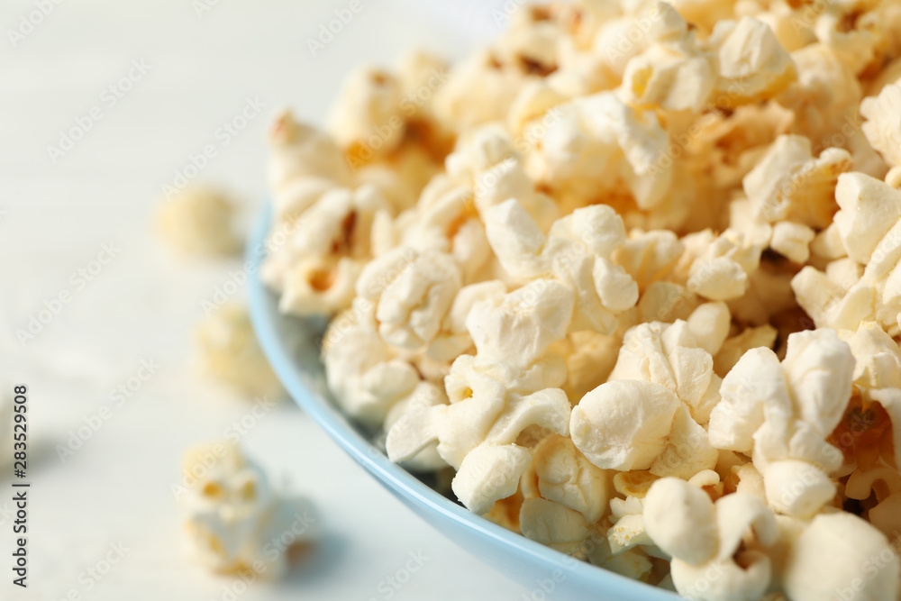 Plate with popcorn on white background, space for text Plate with popcorn on white background, space for text