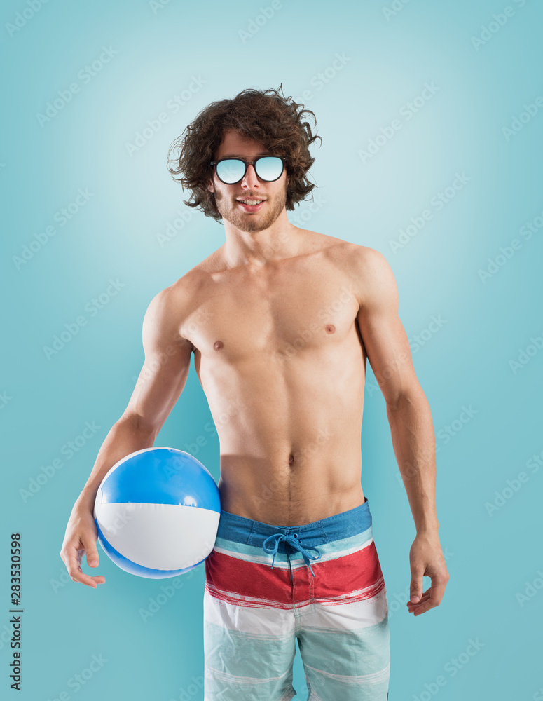 Boy with swimsuit on light blue background