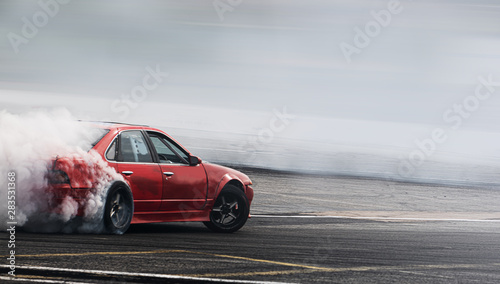 Car drifting, Burning rubber wheel drifting with a lot of smoke. photo