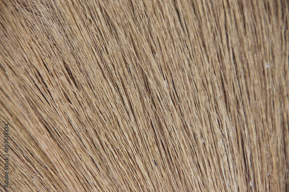 the figure from the top of the broom is made from a tree of grass. the handle is made of bamboo the figure from the top of the broom is made from a tree of grass. the handle is made of bamboo