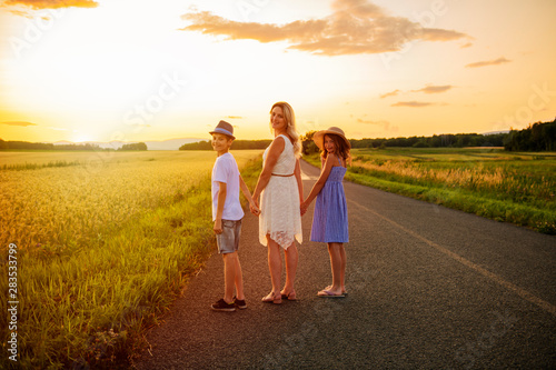 happy family at sunset. They having fun and playing in nature at sunset