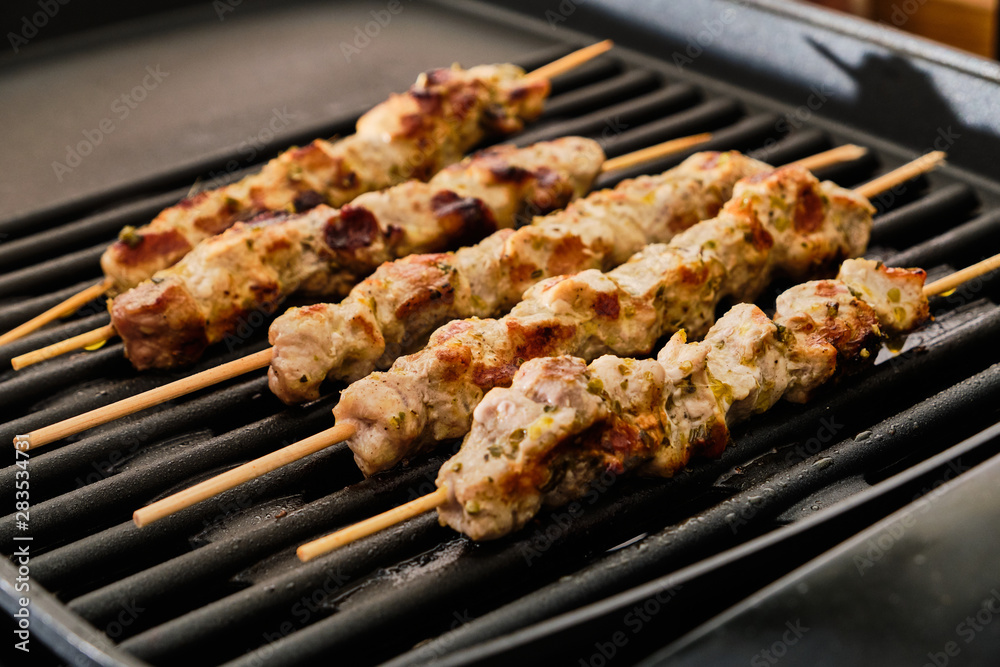 Cooking souvlaki on grill Cooking souvlaki on grill