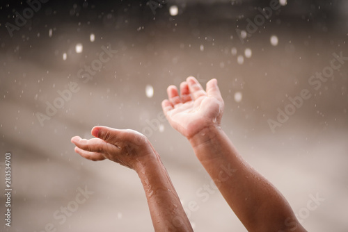 Child hands and rain