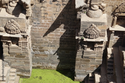 india - rajasthan - jaipur - dausa - chand baori - stepwell - march 28, 2018 little moss water appears in stepwell photo