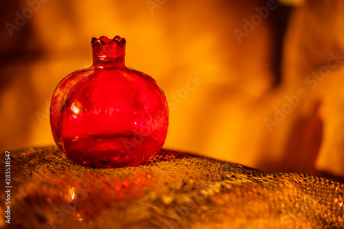 pomegranate red glass vase with beautiful bokeh on background
