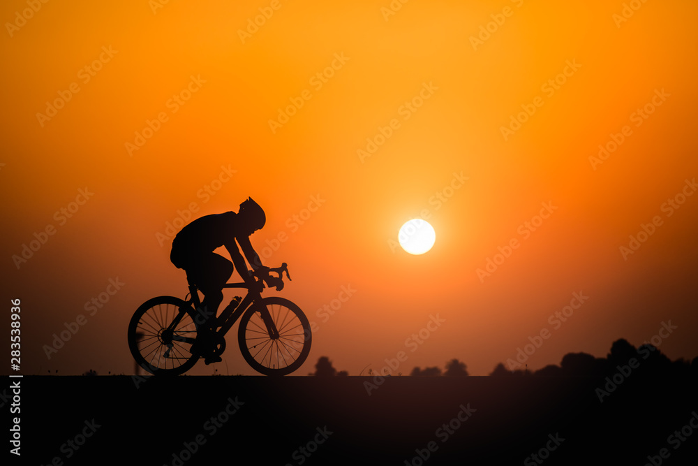 Silhouette man cycling on sunset background Silhouette man cycling on sunset background