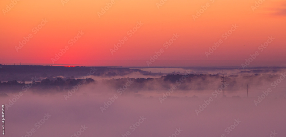 Sunrise on misty valley