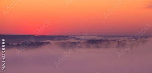 Sunrise on misty valley