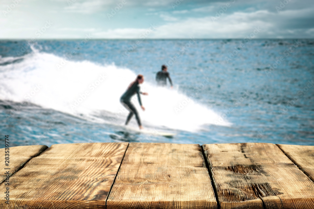 Table background and surfers in the sea view