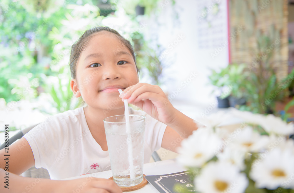Cate Asian girl drinking glass of water with ice Cate Asian girl drinking glass of water with ice
