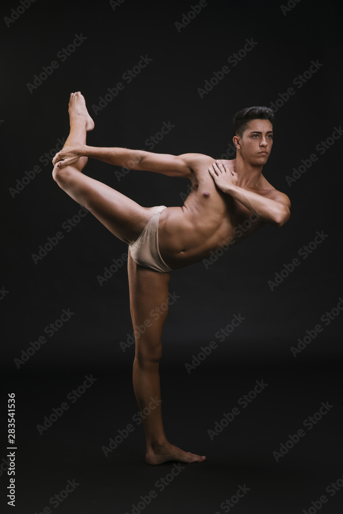 Muscular dancer stretching leg and shoulder Muscular dancer stretching leg and shoulder