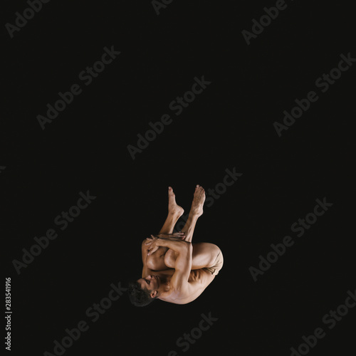 Young acrobat jumping somersault
