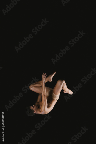 Gymnast doing somersault exercise in air
