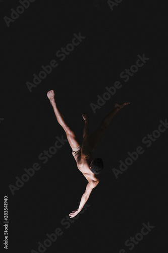 Male gymnast performing in air