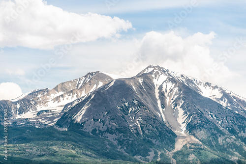 Mt Sopris view in Colorado town with closeup of snow mountain view with peak and sky in summer