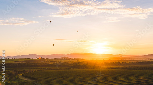 Hot Air Balloon Sunrise Over Fields
