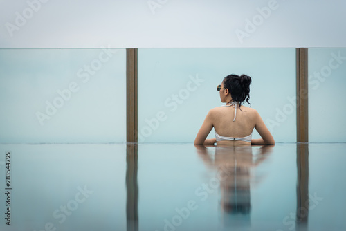 cute Asian women relax in swimming pool