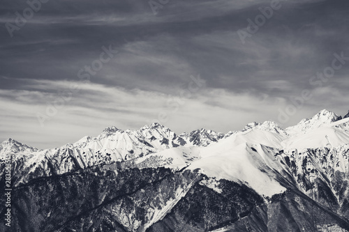 Sunlight snowy mountains and sky with clouds in sunny day © BSANI