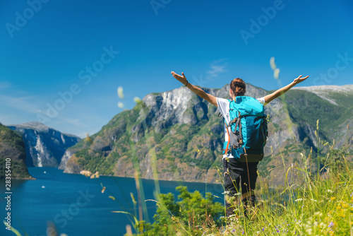 Traveling girl hiking with backpack in mountains adventure journey lifestyle vacations weekend Norway