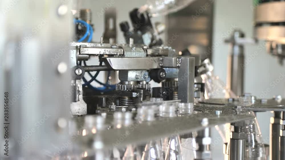 Automatic Water bottling line in plastic white bottles. Plastic bottles are sent to the line. Automatic Water bottling line in plastic white bottles. Plastic bottles are sent to the line.