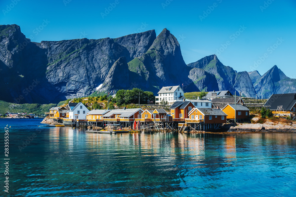 View of the city of Rhine on the Lofoten islands, a beautiful bright landscape, white and red houses on the background of rocks