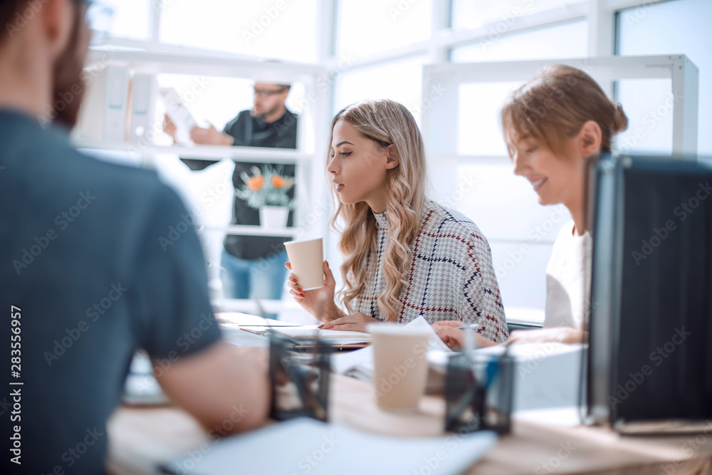 two young women sitting at the office table two young women sitting at the office table